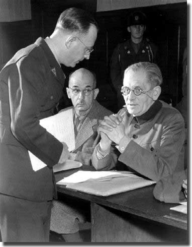 Mr. Lambertus Wartena, Chief of the Administrative Section of the Defense Information Center in Nuernberg, assists Field Marshal Maximillian von Weichs with his application for defense counsel. Von Weichs and eleven other high Wehrmacht officers were indicted on 10 May 1947 on charges of War Crimes and Crimes against Humanity committed during the German Occupation of the Southeast. Looking on, center, is Field Marshal Wilhelm List.