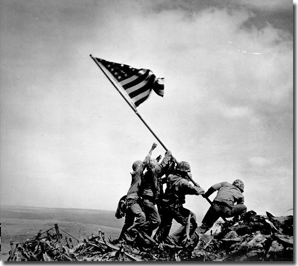 The raising of OLD GLORY at Iwo Jima.