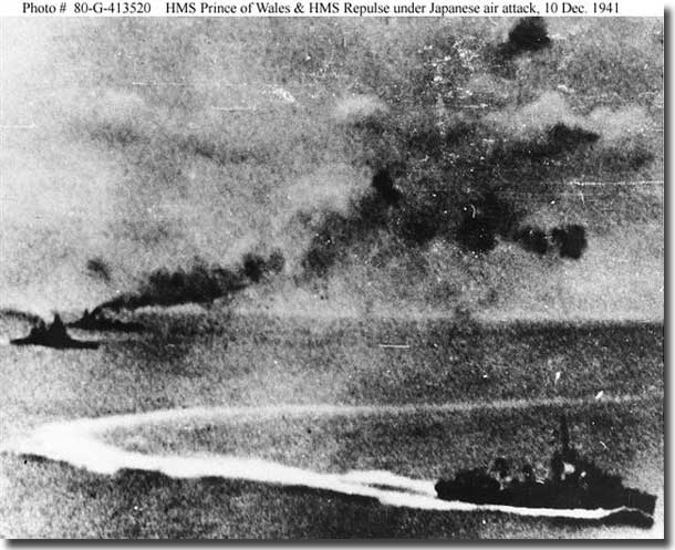 Photograph taken from a Japanese plane, with Prince of Wales at far left and Repulse beyond her. A destroyer, either Express or Electra, is maneuvering in the foreground. Dulin and Garzke's "Allied Battleships in World War II", page 199, states that this photograph was taken "after the first torpedo attack, during which the Prince of Wales sustained heavy torpedo damage." Official U.S. Navy Photograph, now in the collections of the National Archives. 