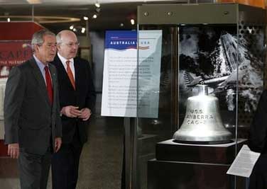 President Bush, left, and Sen. George Brandis, Australia's Minister of Arts and Sport, view the USS Canberra ship's bell,