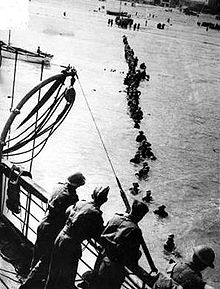 British troops wade out to waiting ships at Dunkirk