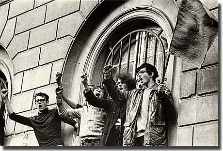 Photo of Students defiantly waving a red flag at the Sorbonne