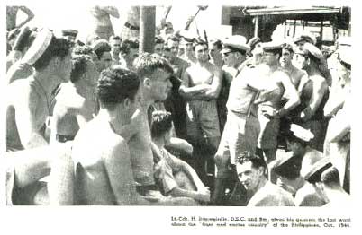 Lieutenant Commander Warwick Bracegirdle (Braces) revs up his gunnery team before the Leyte landings in the Phillipines in October 1944.