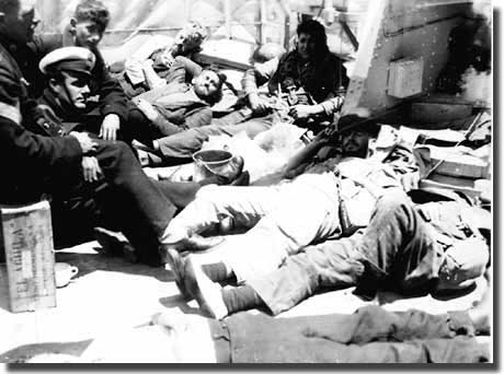 Men resting on deck of Achilles after the Battle of the River Plate