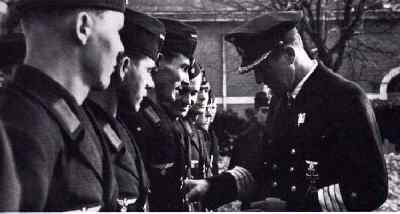 Capt Rogge is seen here bestowing decorations to his men from the Atlantis